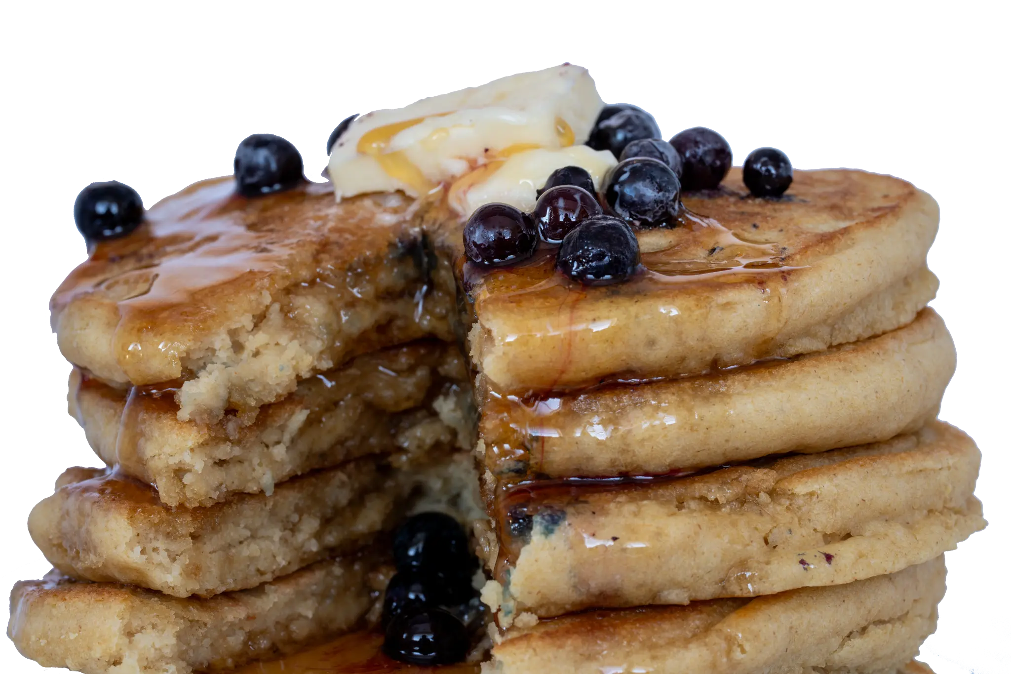 Stack of golden blueberry pancakes with butter and syrup