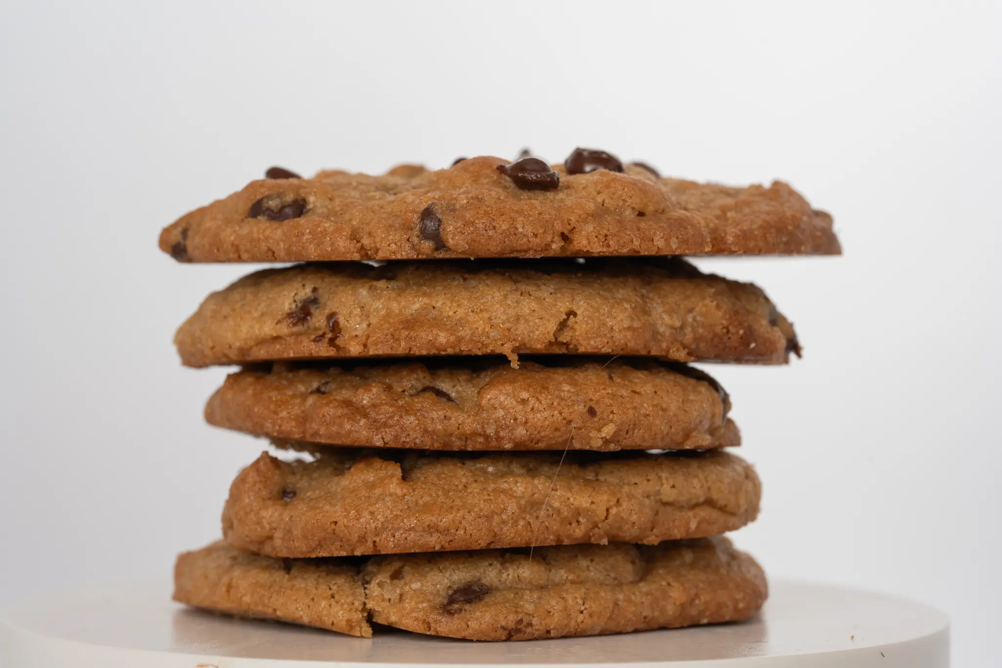 Stack of freshly baked gluten-free dairy-free chocolate chip cookies made with Genell Asil Premium Cookie Mix